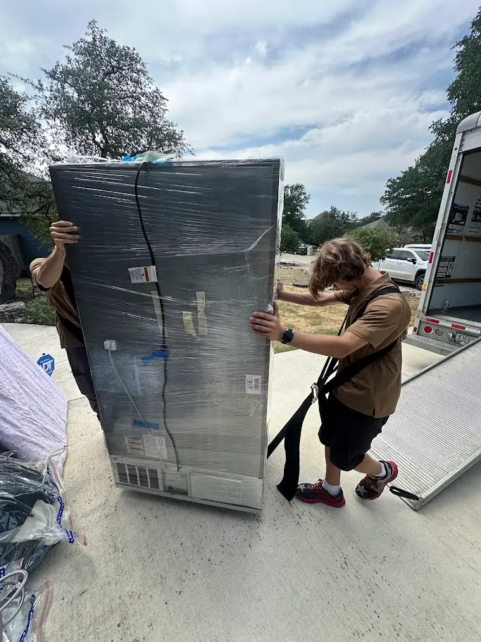 How to Pack Fragile Items Like a Pro 2 Movers wrapping a refrigerator for a San Antonio move