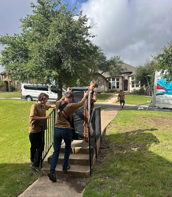 Blog 22 Two Step Moving crew carrying wrapped furniture up steps during a San Antonio, TX home move
